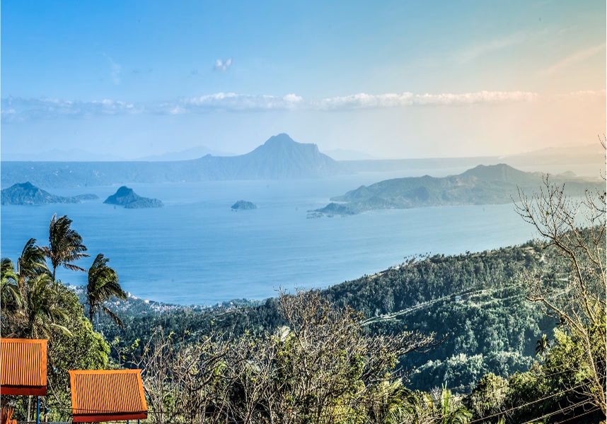 A scenic view of a lake with islands and mountains in the background